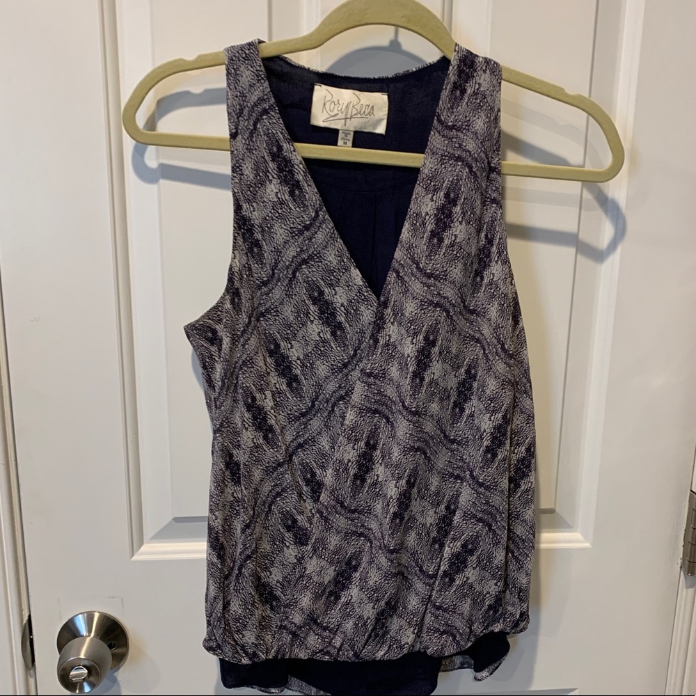 V-neck wrap style with blousy gather at bottoms for flattering fit